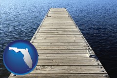 florida map icon and a boat dock on a blue water lake