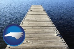 north-carolina map icon and a boat dock on a blue water lake