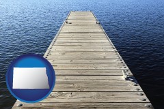north-dakota map icon and a boat dock on a blue water lake