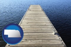 nebraska map icon and a boat dock on a blue water lake