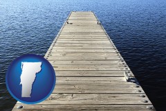 vermont map icon and a boat dock on a blue water lake
