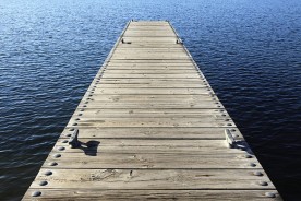 a boat dock on a blue water lake
