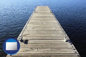 a boat dock on a blue water lake - with Colorado icon