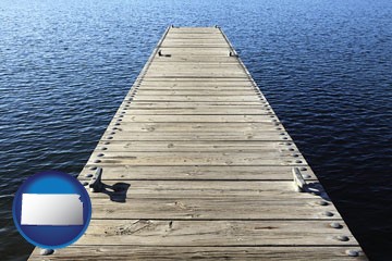 a boat dock on a blue water lake - with Kansas icon