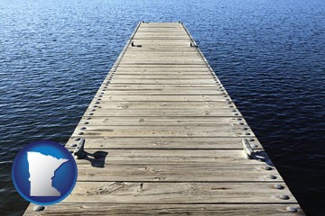 a boat dock on a blue water lake - with Minnesota icon