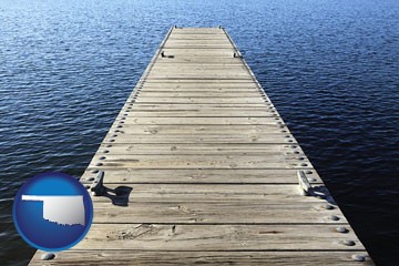 a boat dock on a blue water lake - with Oklahoma icon