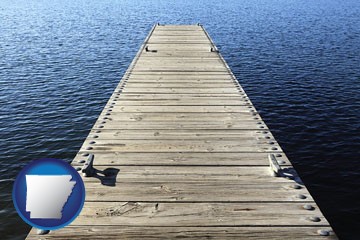 a boat dock on a blue water lake - with Arkansas icon